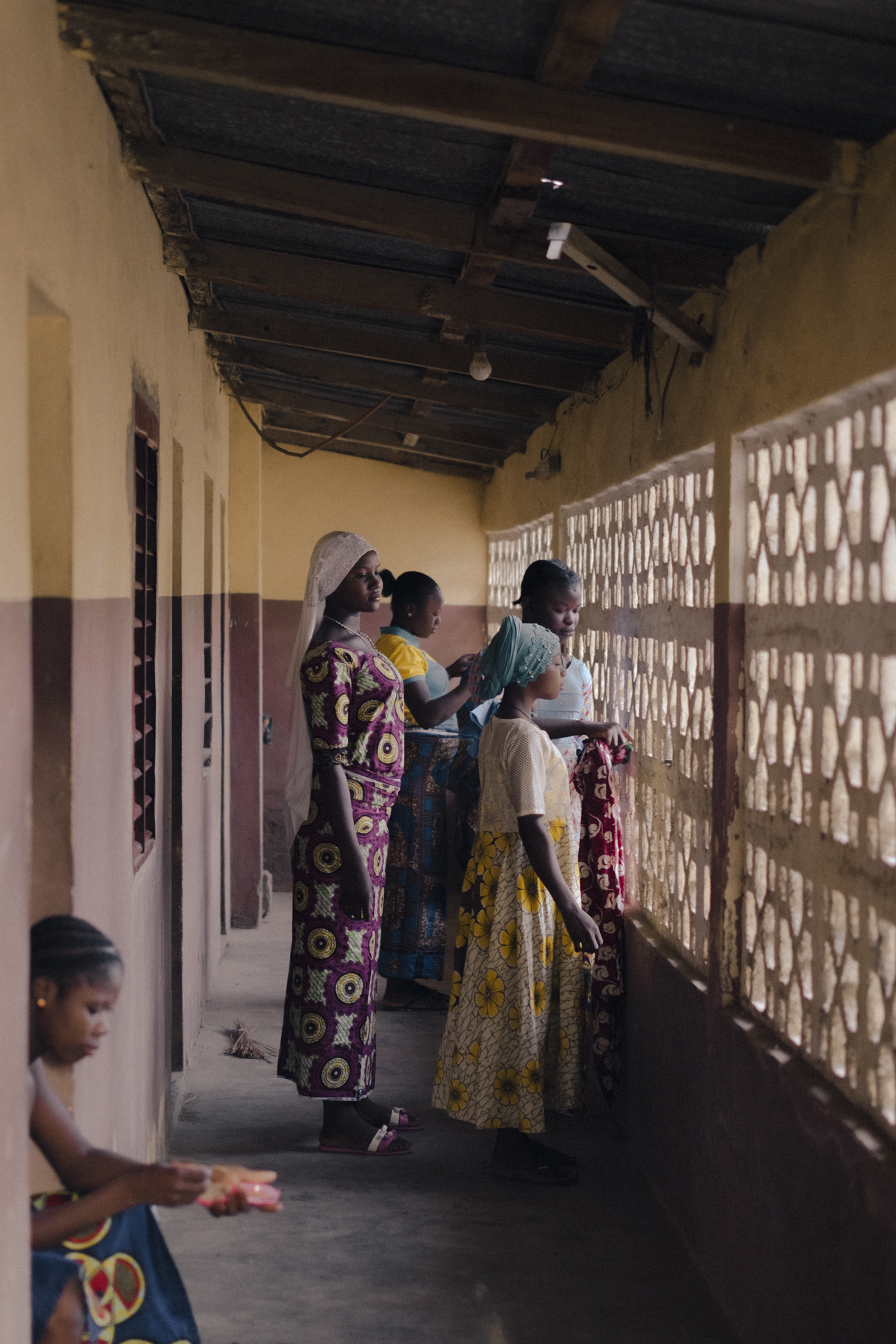 Benin. Kandi. The girls getting ready on a Sunday morning before going to church near the boarding school. 2023